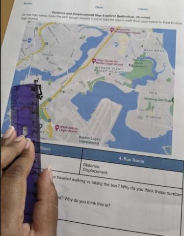 A student is measuring the distance after drawing their walking route to school on the worksheet map.