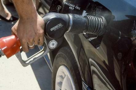 A person filling a car with unleaded gasoline.