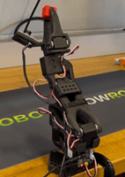 A photo showing the SO-101 AI Robot holding the red cube with end effector (grippers). A photo showing the SO-101 AI Robot holding the red cube with end effector (grippers).