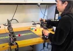 A photo showing a teacher teleoperating the SO-101 arm leader at the AI lab. A photo showing a teacher teleoperating the SO-101 arm leader at the AI lab.