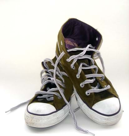 A photograph shows a pair of dark green high-top laced sneakers with rubber soles, edges and toe caps.