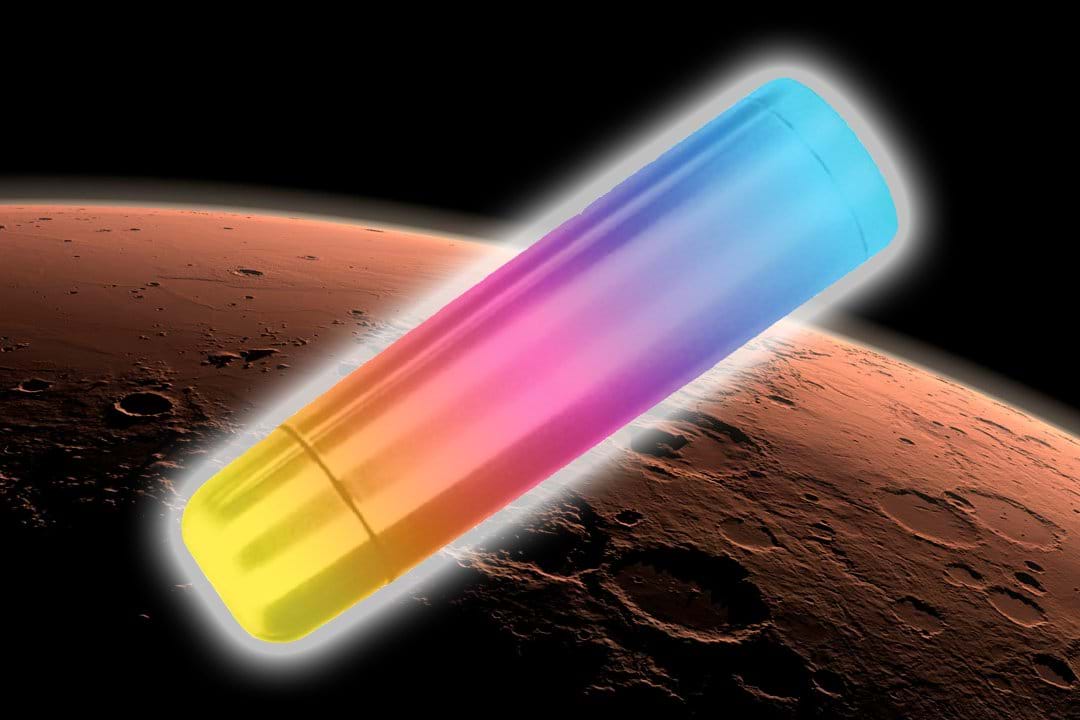 A digitally edited image showing a colorful thermos floating above the surface of Mars. The thermos is elongated and cylindrical, with a gradient of colors transitioning from yellow at the bottom, through pink and purple in the middle, to blue at the top. The planet Mars is shown below, and the background is black space. A digitally edited image showing a colorful thermos floating above the surface of Mars. The thermos is elongated and cylindrical, with a gradient of colors transitioning from yellow at the bottom, through pink and purple in the middle, to blue at the top. The planet Mars is shown below, and the background is black space.
