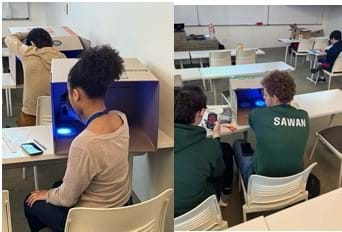 Two photos, each showing students shining their UV flashlights on their person-shapes on photoluminescent paper while timing themselves (or with a group member) for the 2-minute UV light exposure.