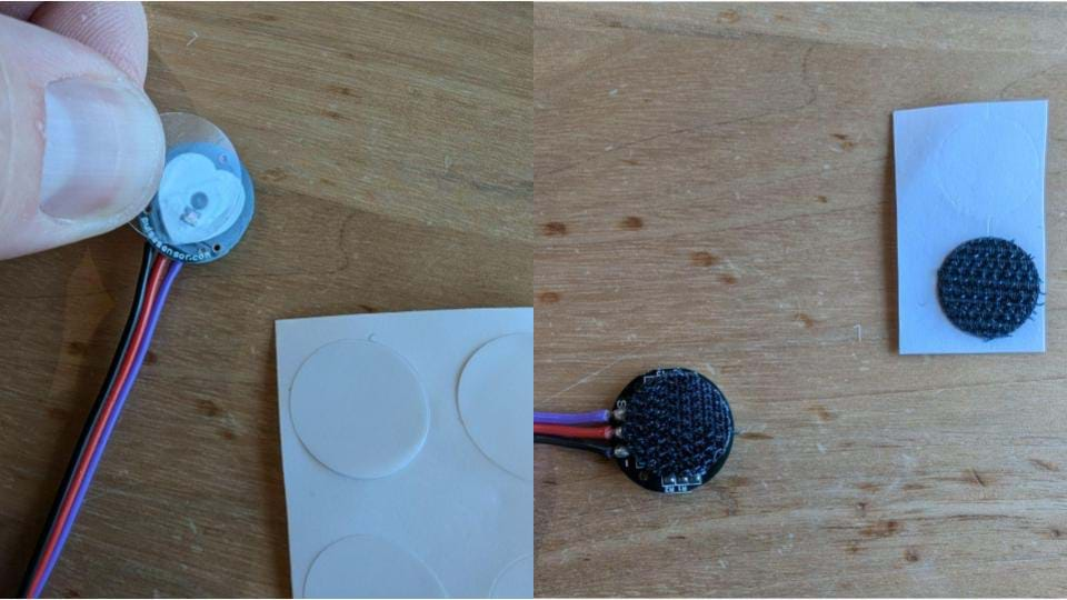 A photo showing how to place the stickers onto the pulse sensor to ready it for use.  