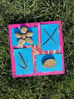 A photo showing objects found from nature (rocks, sticks, flowers) placed on construction paper, then exposed to sunlight to begin the cyanotype printing process. A photo showing objects found from nature (rocks, sticks, flowers) placed on construction paper, then exposed to sunlight to begin the cyanotype printing process.
