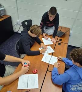 A photo of students working though gate paperwork. A photo of students working though gate paperwork.