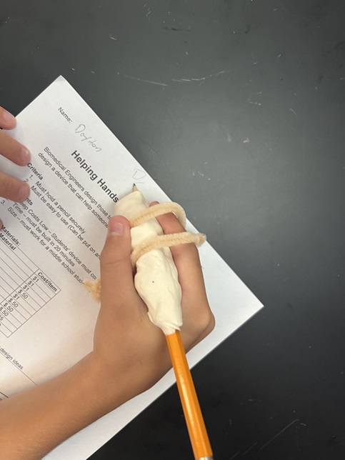 A photo showing a student testing their device.  