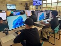 A photo showing students working on their lab computers. A photo showing students working on their lab computers.