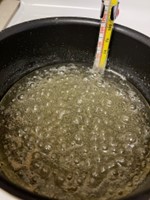 A photo of the boiling water/sugar and the thermometer indicating a temperature higher than 100 °C.