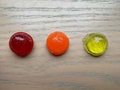 A photo showing a water solution gummy that is red, a sugar solution gummy that is orange, and a salt solution gummy that is yellow. A photo showing a water solution gummy that is red, a sugar solution gummy that is orange, and a salt solution gummy that is yellow.